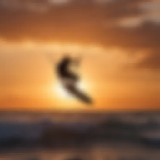 Silhouette of a kite surfer against a fiery sunset sky