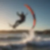 Kiteboarder performing a stylish jump over waves