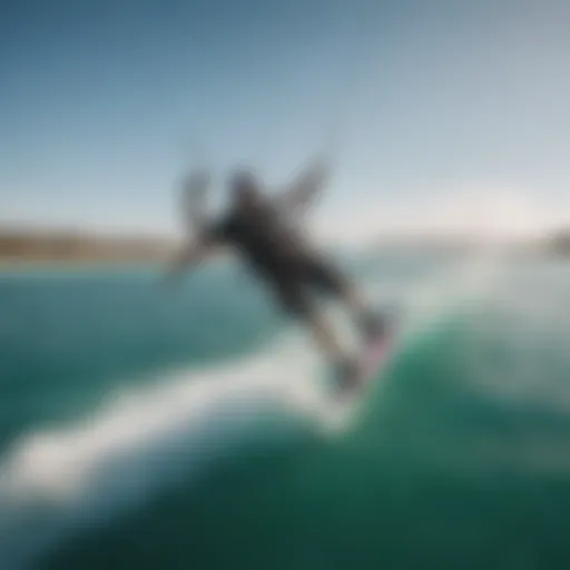 Aerial view of a kiteboarder performing a jump over crystal-clear waters