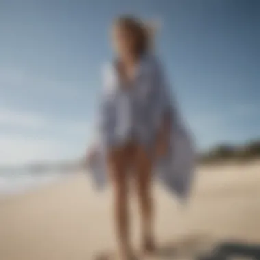 A stylish Mystic towel poncho displayed on a beach setting, showcasing its unique design.