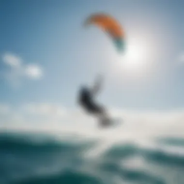 Kiteboarder riding waves under clear blue skies on Oahu