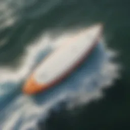 Aerial view of a sleek surfboard on ocean waves