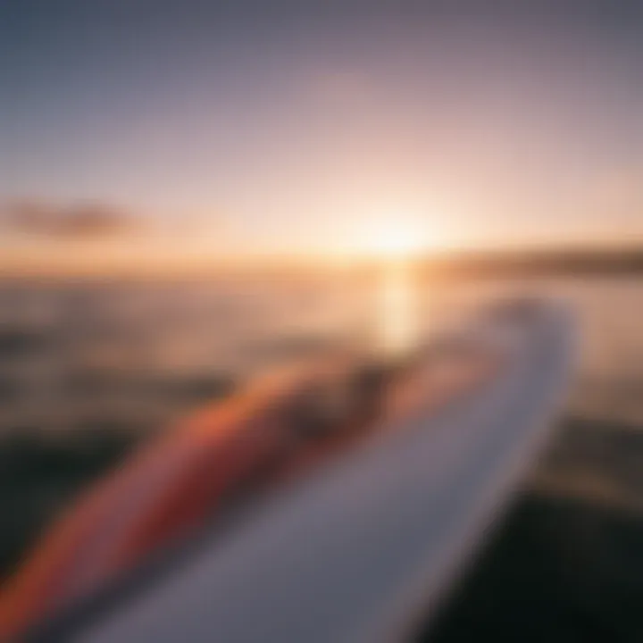 A pristine wing foil board in a sunset-lit setting