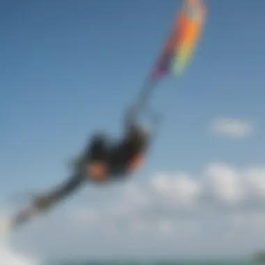 Close-up of kiteboarder executing a stylish trick with colorful kite in the background