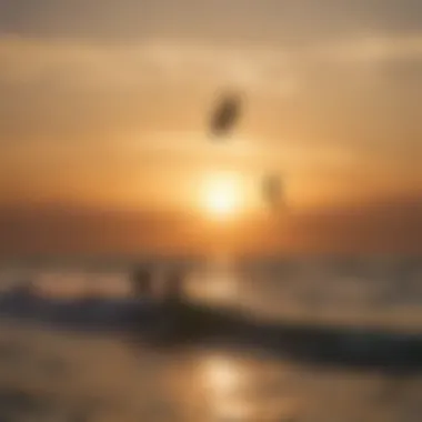 Silhouetted kiteboarders riding the waves during a stunning sunset