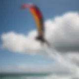 Kitesurfing athlete executing a perfect aerial maneuver over the waves