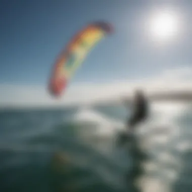 Scenic shot of a kiteboarder gliding across the water with the Ozone Trainer Kite