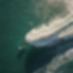 Aerial view of kitesurfers riding waves with shorts harness