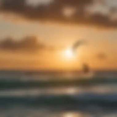 Silhouette of a kiteboarder gliding on the waves at sunrise in Antigua