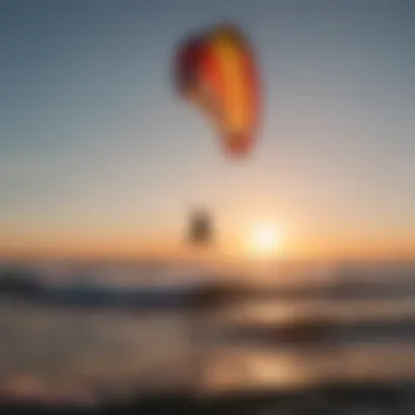 Silhouette of a kitesurfer riding the waves with an inflatable kite at sunset