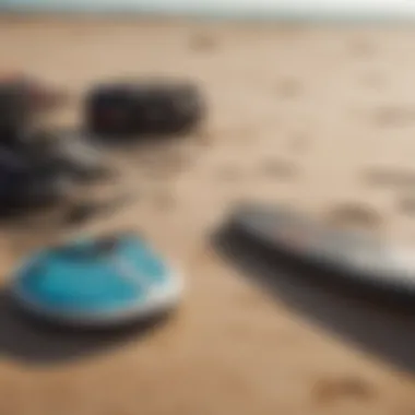 Close-up of kitesurfing gear laid out on sandy beach ready for action