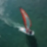 Aerial view of starboard inflatable windsurfing setup on crystal clear waters