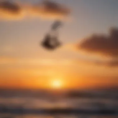 Silhouette of kitesurfer against the sunset while executing a hangtime koala