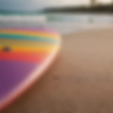 Close-up of a surfboard on the sandy beach with vibrant colors.