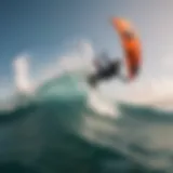 A kitesurfer executing a backroll over a vibrant ocean wave.