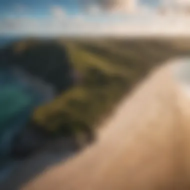 An aerial view of a vibrant small kite soaring above a stunning beach landscape.