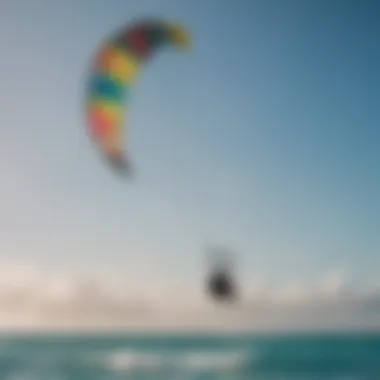 Rider gliding through crystal-clear waters with colorful kite in the sky