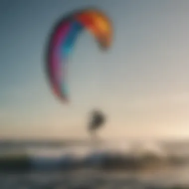 Silhouette of a kitesurfer riding waves with a dynamic kite in the background