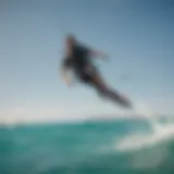 A breathtaking view of a kite boarder gliding over turquoise waters.