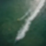 Aerial view of kitesurfers riding the waves with colorful kites