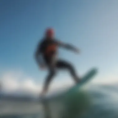 Kitesurfer riding the waves under a clear blue sky