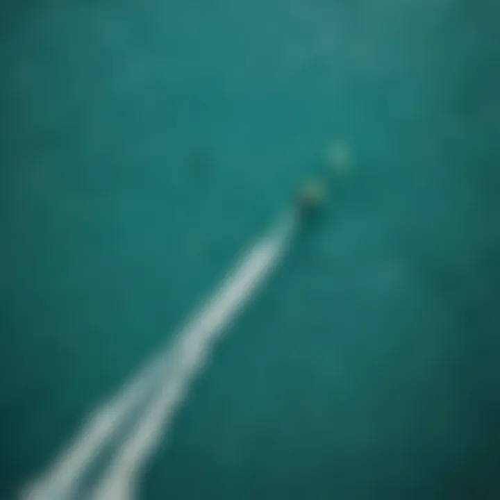 Overhead shot of kitesurfers enjoying airtime in turquoise waters