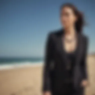 Long black camisole paired with a tailored blazer and statement necklace