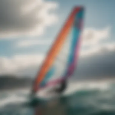 Windsurfer riding the waves with a colorful sail unfurled