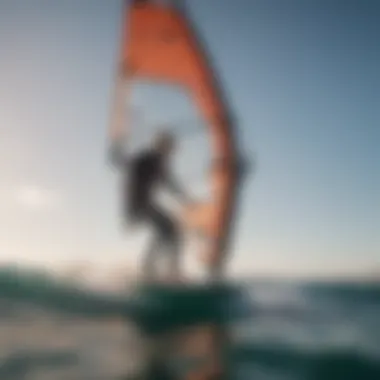 A windsurfer in action, fully equipped with a dry suit against a stunning ocean backdrop.